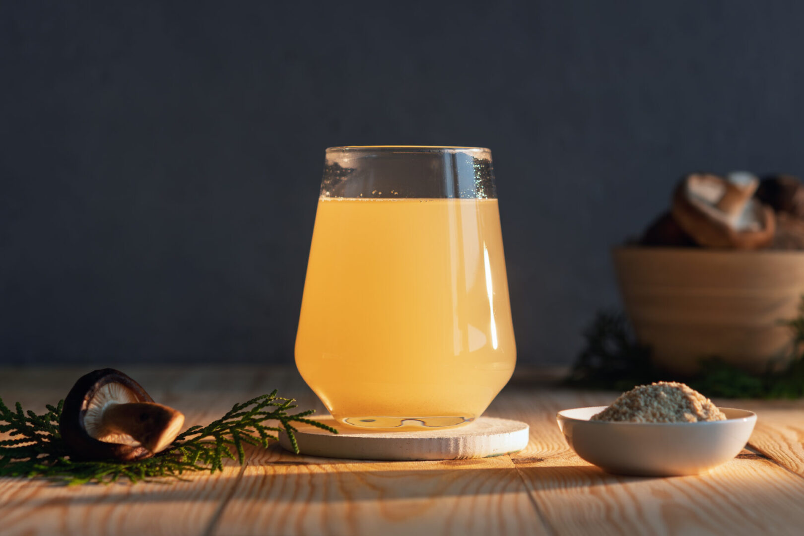 Glass of yellow drink on table