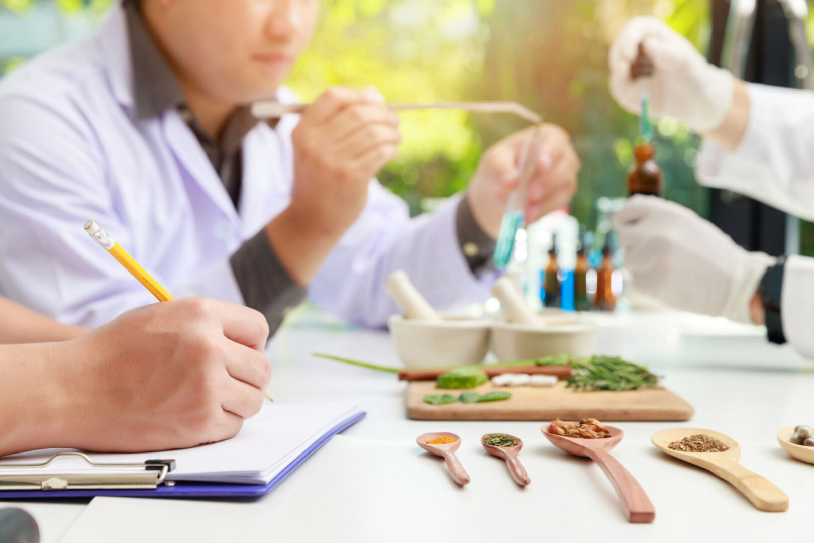 Researchers analyzing herbs with lab equipment.